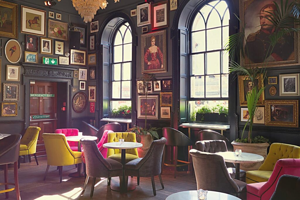 Luxurious interior of a Dublin cafe featuring vibrant seating and eclectic art decor.